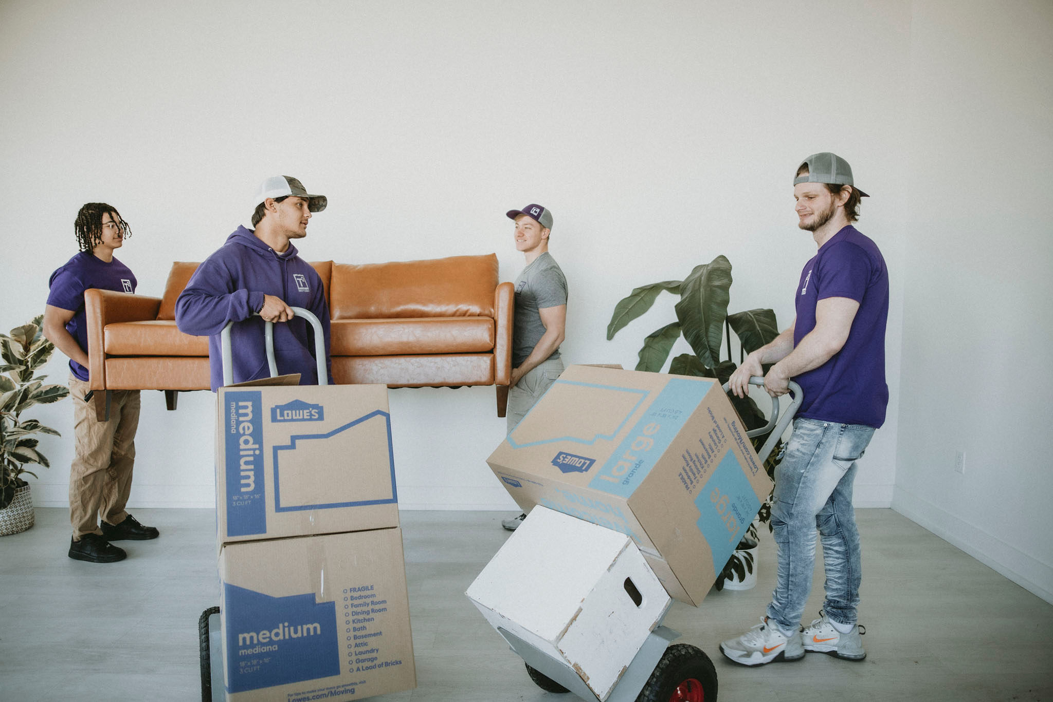 our movers at work moving boxes and lifting a couch